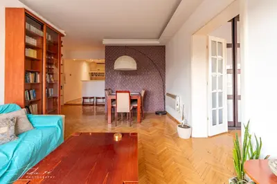 a living room with a blue couch and a table at The View That Never Gets Old - Kalemegdan in Belgrade