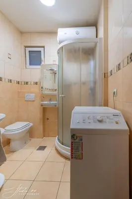 a small bathroom with a shower and a toilet at The View That Never Gets Old - Kalemegdan in Belgrade