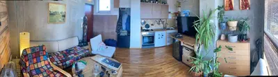 a living room with a couch and a kitchen at Krov in Belgrade