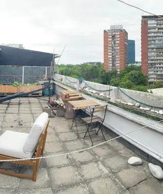 a table and chairs on top of a roof at Krov in Belgrade