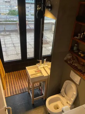a bathroom with a white toilet and a sink at Krov in Belgrade