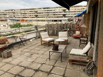 a patio with chairs and tables and a building at Krov in Belgrade