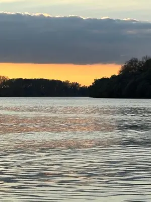 a view of a large body of water at sunset at Kuća na obali Save in Obrenovac