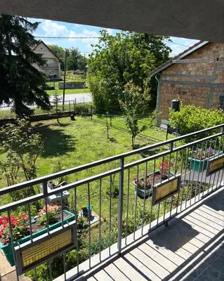 a view of a garden from a balcony with benches at Kuća na obali Save in Obrenovac