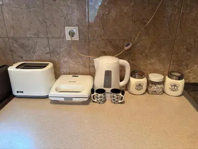 a kitchen counter with a coffee maker and toasters at Kuća na obali Save in Obrenovac