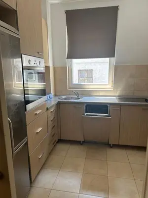 a small kitchen with a sink and a window at Cozy two bedroom in Belgrade in Belgrade