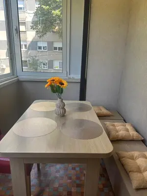 a table with a vase of flowers on top of it at Cozy two bedroom in Belgrade in Belgrade