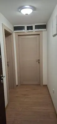 a hallway with two garage doors and a wooden floor at Bingo's apartman in Belgrade