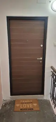 a garage door with a sign that reads never enter at Bingo's apartman in Belgrade