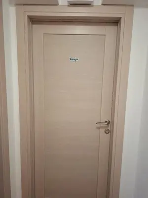a door with the word warranty written on it at Vanja's Apartman in Belgrade