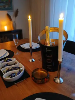 a table with a bottle of champagne and candles on it at House therapy in Sremčica