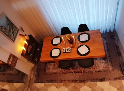 a wooden table with chairs in a room at House therapy in Sremčica