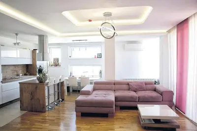 a living room with a couch and a kitchen at 3BD Luxury Apartment in New Belgrade whit parking in Novi Beograd