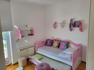 a childs room with a pink couch and a shelf at 3BD Luxury Apartment in New Belgrade whit parking in Novi Beograd