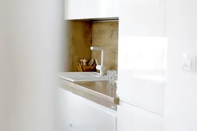 a white bathroom with a sink and a counter at 3BD Luxury Apartment in New Belgrade whit parking in Novi Beograd