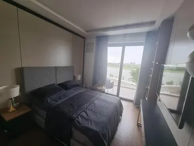 a bedroom with a bed and a large window at Exclusive apartman BW Terraces in Belgrade