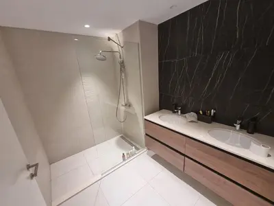 a bathroom with two sinks and a shower at Exclusive apartman BW Terraces in Belgrade