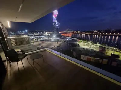 a room with a view of a city at night at Exclusive apartman BW Terraces in Belgrade