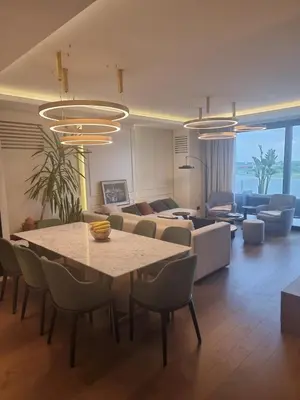 a living room with a table and a couch at Exclusive apartman BW Terraces in Belgrade