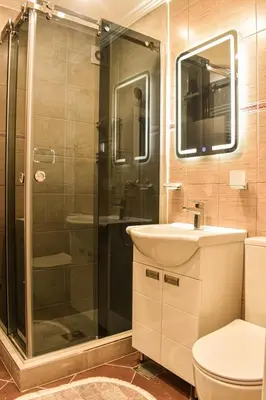 a bathroom with a shower and a sink and a toilet at Urban Duplex in Belgrade