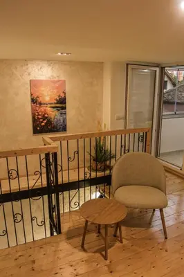 a living room with a chair and a table at Urban Duplex in Belgrade