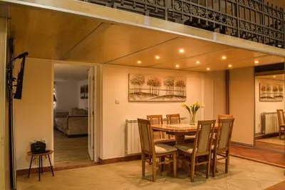 a dining room with a table and chairs at Urban Duplex in Belgrade