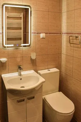a bathroom with a sink and a toilet and a mirror at Urban Duplex in Belgrade