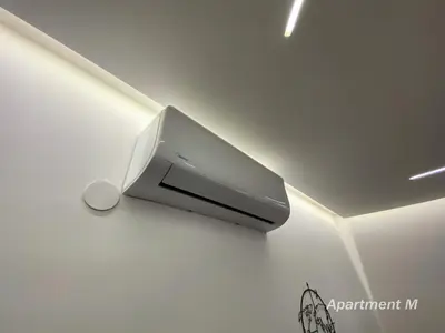 a tv hanging on a wall in a room at Apartman M in Belgrade