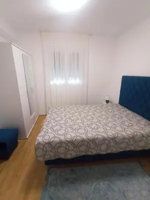 a bedroom with a bed and a blue chair at Vintage Village Serbia