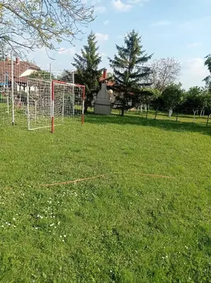 a soccer field with a net in the grass at Vintage Village Serbia