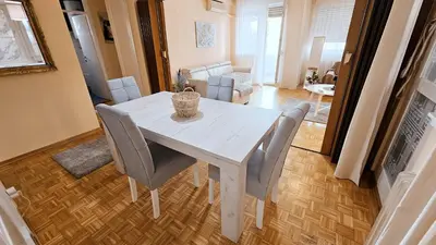 a white dining table and chairs in a living room at Old Town View Apartment in Belgrade
