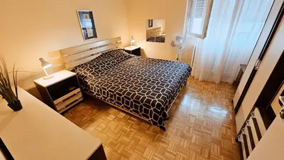 a bedroom with a bed with a black and white comforter at Old Town View Apartment in Belgrade