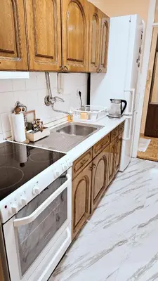 a kitchen with wooden cabinets and a sink at Old Town View Apartment in Belgrade