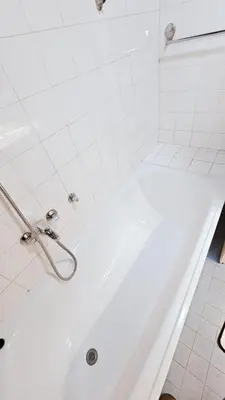 a white bath tub in a white tiled bathroom at Old Town View Apartment in Belgrade