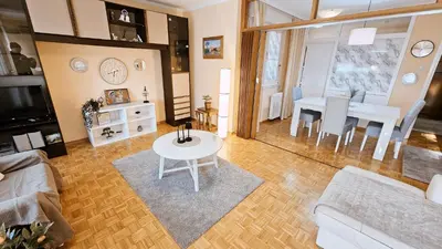 a living room with a white table and a dining room at Old Town View Apartment in Belgrade