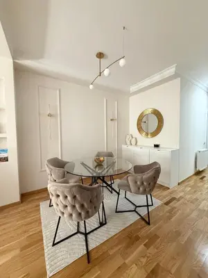 a dining room with a glass table and chairs at DILL apartman Arandjelovac in Arandjelovac