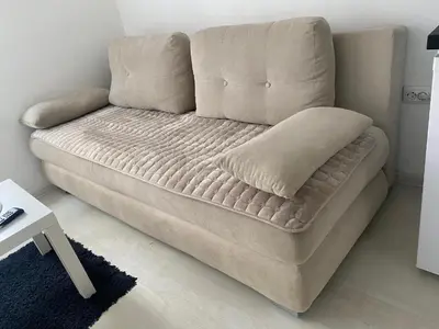 a couch sitting in a living room with a pillow at Belgrade Center Lux in Belgrade