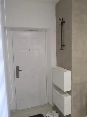 a bathroom with a white door and a toilet at Belgrade Center Lux in Belgrade