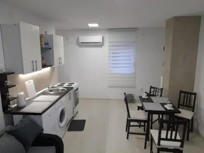 a kitchen with a stove and a table with chairs at Belgrade Center Lux in Belgrade