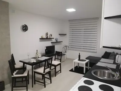 a living room with a table and a couch at Belgrade Center Lux in Belgrade