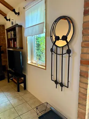 a mirror hanging on a wall next to a window at Tiny Home L&B in Belgrade