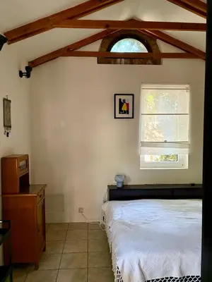 a bedroom with a bed and a window at Tiny Home L&B in Belgrade