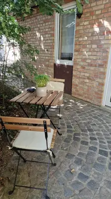 a picnic table and chairs on a patio at Tiny Home L&B in Belgrade