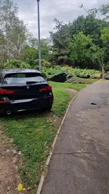 a car parked on the grass next to a street at Tiny Home L&B in Belgrade