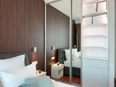 a bedroom with a mirror and a bed at Arkadija Lux Apartment River And Tower View in Belgrade