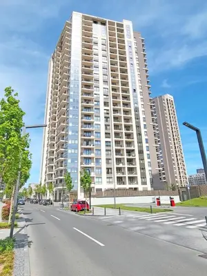 a large building on the side of a street at Arkadija Lux Apartment River And Tower View in Belgrade