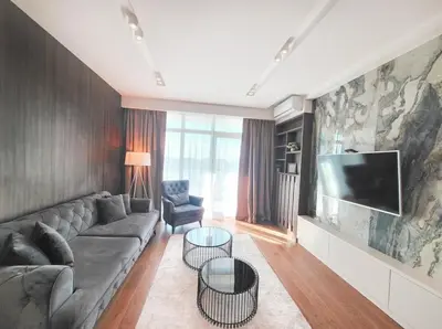 a living room with a couch and a flat screen tv at Arkadija Lux Apartment River And Tower View in Belgrade