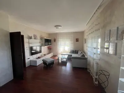a living room with a couch and a table at Apartman FM in Arandjelovac