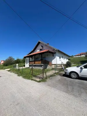 a small house with a car parked in front of it at Apartman FM in Arandjelovac