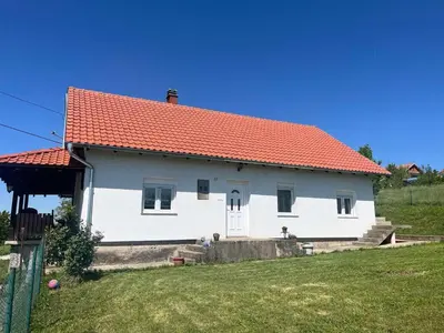 a white house with an orange roof at Apartman FM in Arandjelovac
